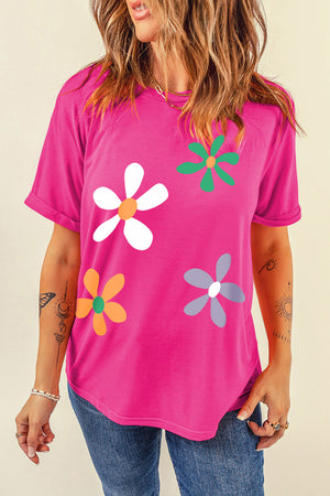 Hot pink t-shirt with a retro daisy graphic print, short sleeves, and a crew neck.
