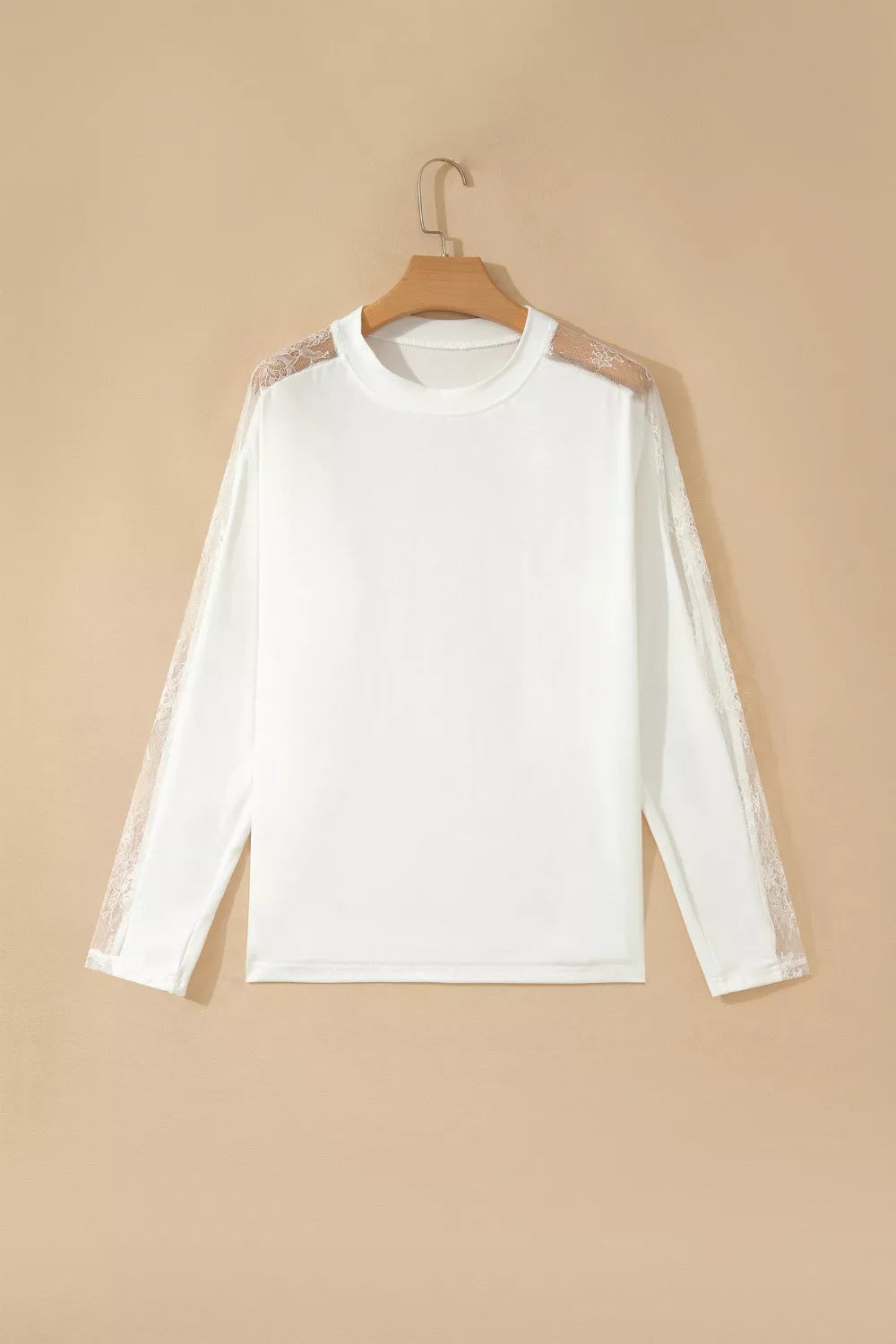 White long sleeve shirt with delicate lace shoulder and sleeve details, crew neckline.