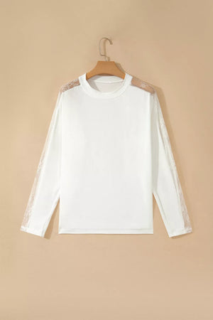 White long sleeve shirt with delicate lace shoulder and sleeve details, crew neckline.