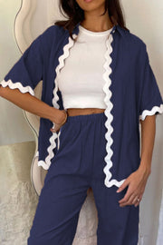 Dark blue scalloped edge co-ord set with white trim, featuring a cropped top and wide-leg pants.