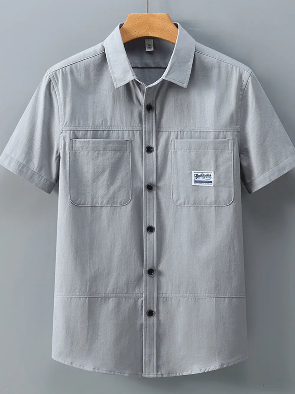 Men's grey cotton short-sleeve utility shirt with two chest pockets and button front.