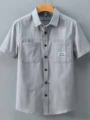 Men's grey cotton short-sleeve utility shirt with two chest pockets and button front.