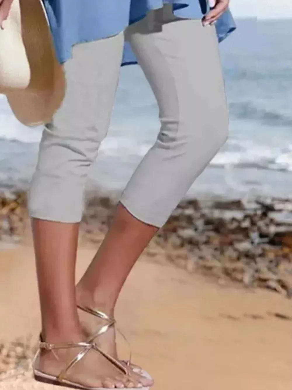 Light gray cropped casual leggings with a capri length, styled with gold sandals.