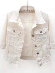White denim trucker jacket with cropped sleeves and button flap chest pockets.