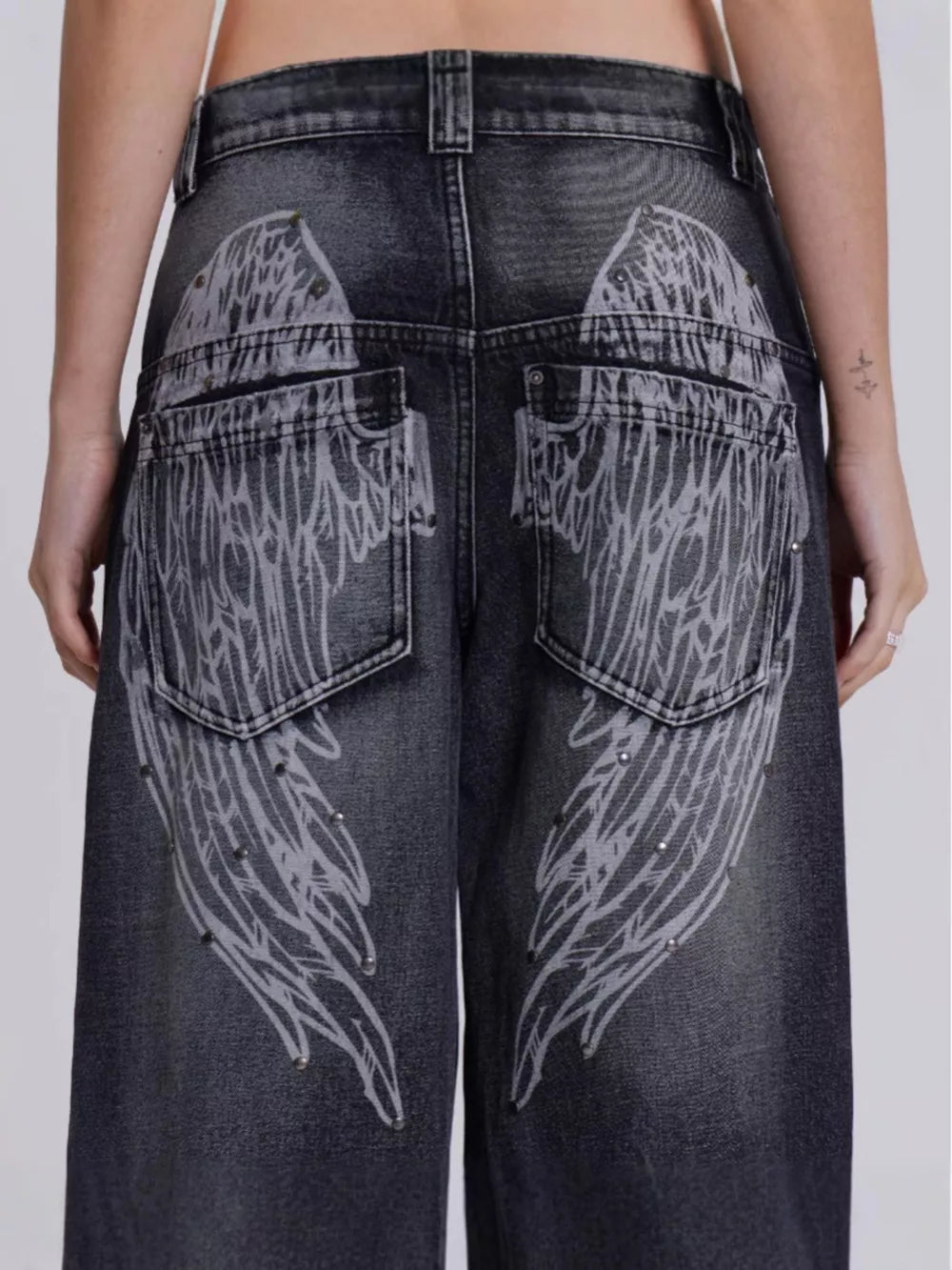 Black wide leg jeans with studded angel wing back pocket detail