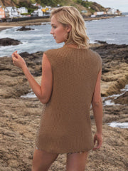 Camel openwork knit vest with vertical ribbing and a button-down front, styled casually.