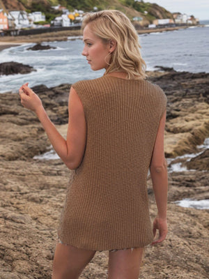 Camel openwork knit vest with vertical ribbing and a button-down front, styled casually.