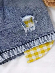 Denim shorts with yellow gingham patch detail and distressed accents.
