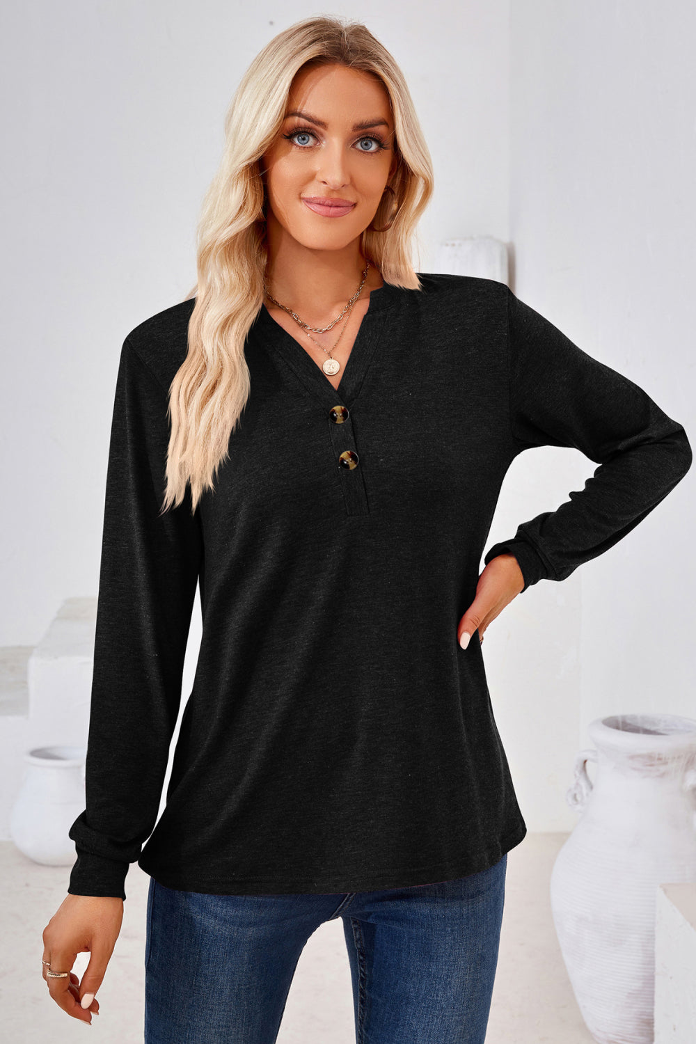 Black henley neckline jersey top with button detail and long sleeves.