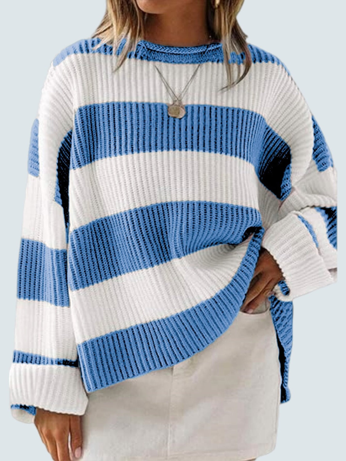 Blue and white striped oversized knit sweater with crew neck and long sleeves.