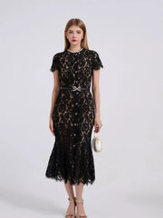 Black floral lace mermaid dress with short sleeves, pearl neckline, and bow belt.