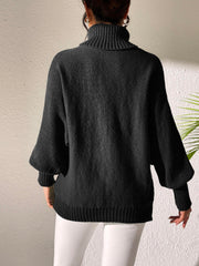 Black balloon sleeve turtleneck sweater with relaxed knit and ribbed cuffs.