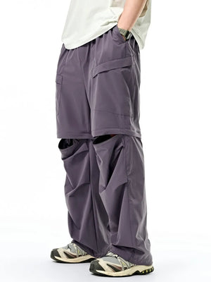 Gray cargo pants with adjustable waist and large pockets, shown with detachable lower legs.
