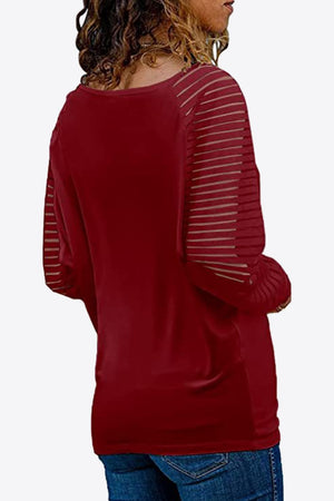 Wine raglan v-neck top with sheer striped sleeves and pleated cuffs.