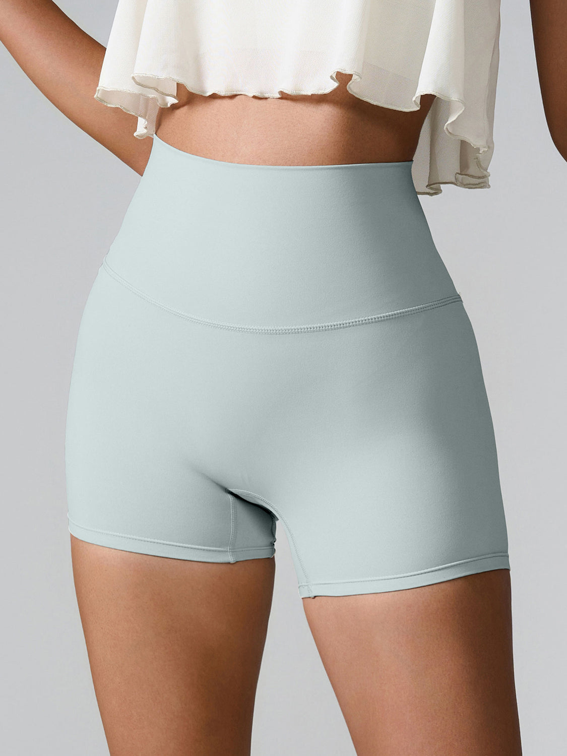 Light Green Sculpted Pocket Detail Active Shorts with high waist and seamless design.