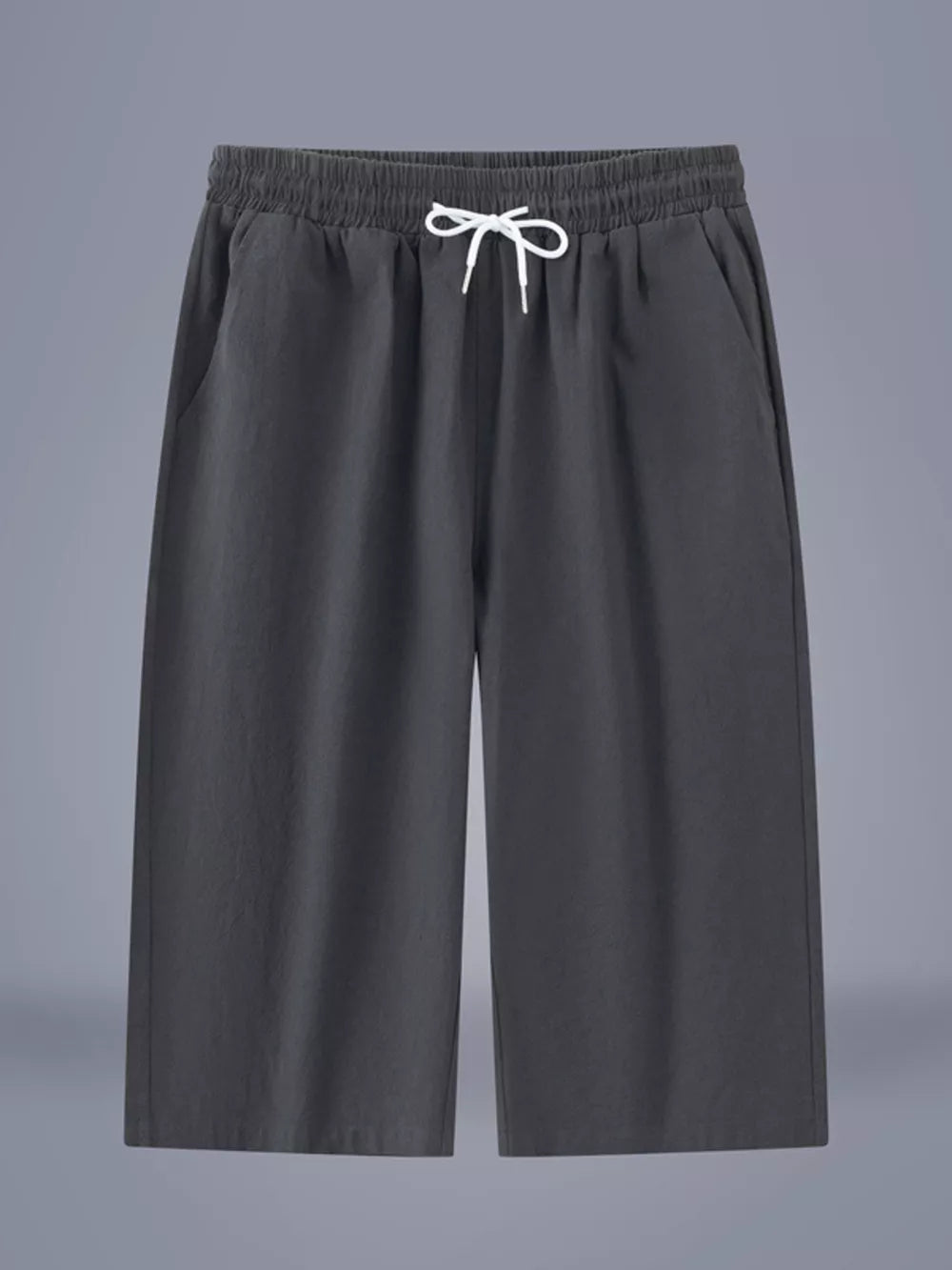 Relaxed plus size cropped sweatpants in dark gray with drawstring waist and pockets.