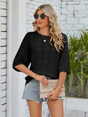 Black openwork box stitch knit top with elbow sleeves and a crew neck.