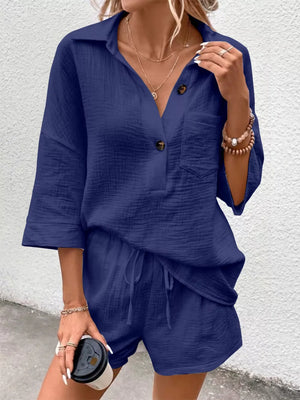 Navy cotton two-piece set with button-up shirt and drawstring shorts.