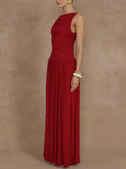 Red ruched maxi dress with asymmetric neckline and flowing skirt.