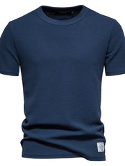 Navy textured crew-neck t-shirt knit with short sleeves and a small patch detail.