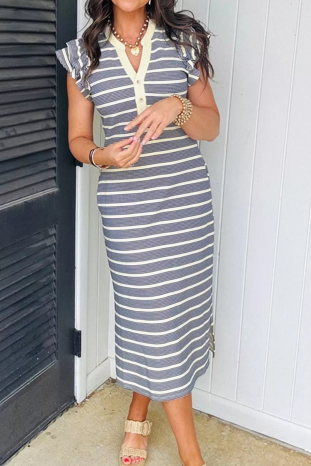 Navy stripe midi dress with ruffled cap sleeves, buttoned V-neck, and pockets.