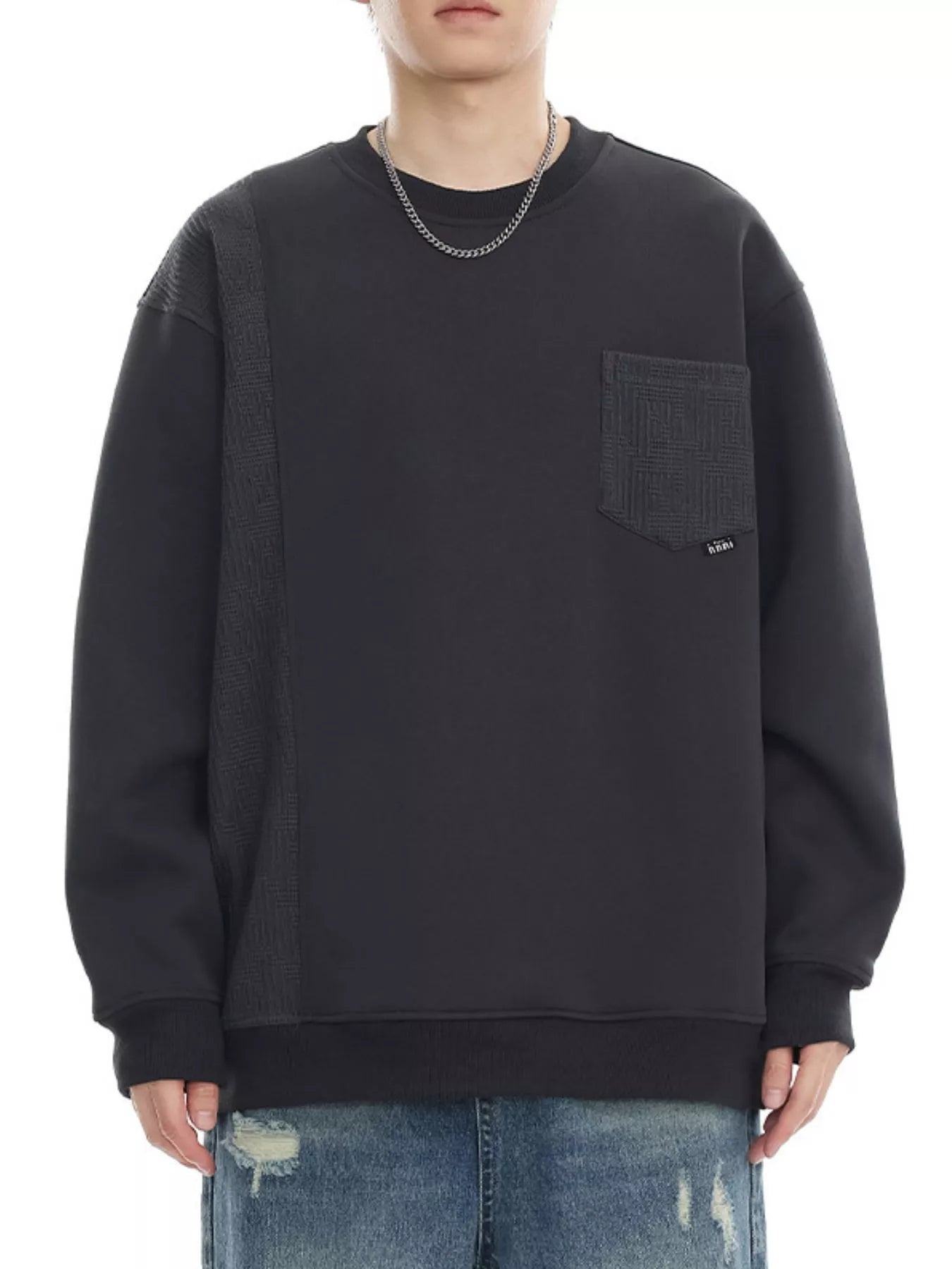 Dark gray sweatshirt with textured side panel and chest pocket, crewneck, long sleeves.