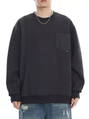 Dark gray sweatshirt with textured side panel and chest pocket, crewneck, long sleeves.