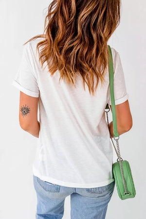 White cotton t-shirt with rolled sleeves and a small eye tattoo on the arm.