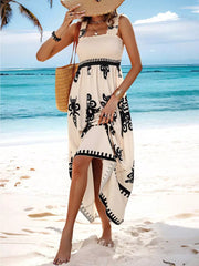 Smocked square neck maxi dress in cream with black print, a-line cut, and ruffled hem.
