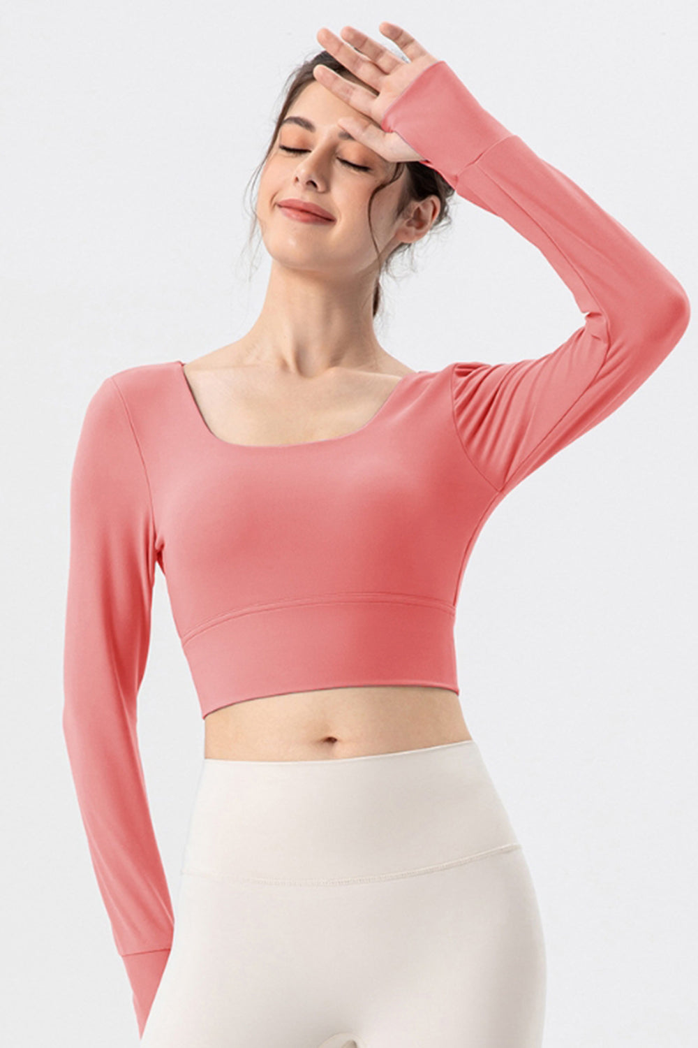 Coral pink long sleeve crop top with thumbholes and square neckline