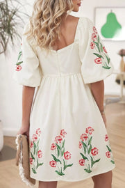 Floral puff sleeve A-line dress with square neckline and embroidered flowers.
