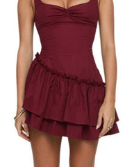 Burgundy ruched ruffled mini dress with sweetheart neckline and tiered skirt.