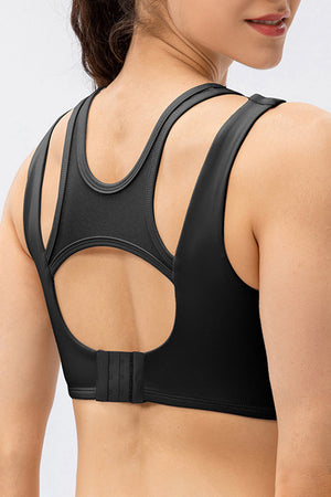 Black mesh inset performance bra top with cutout back detail and adjustable hook closure.