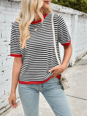 Striped knit tee with red trim and crew neck, styled with light wash jeans.