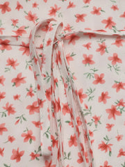 Floral mini dress with V-neck and puff sleeves, featuring a tie detail.