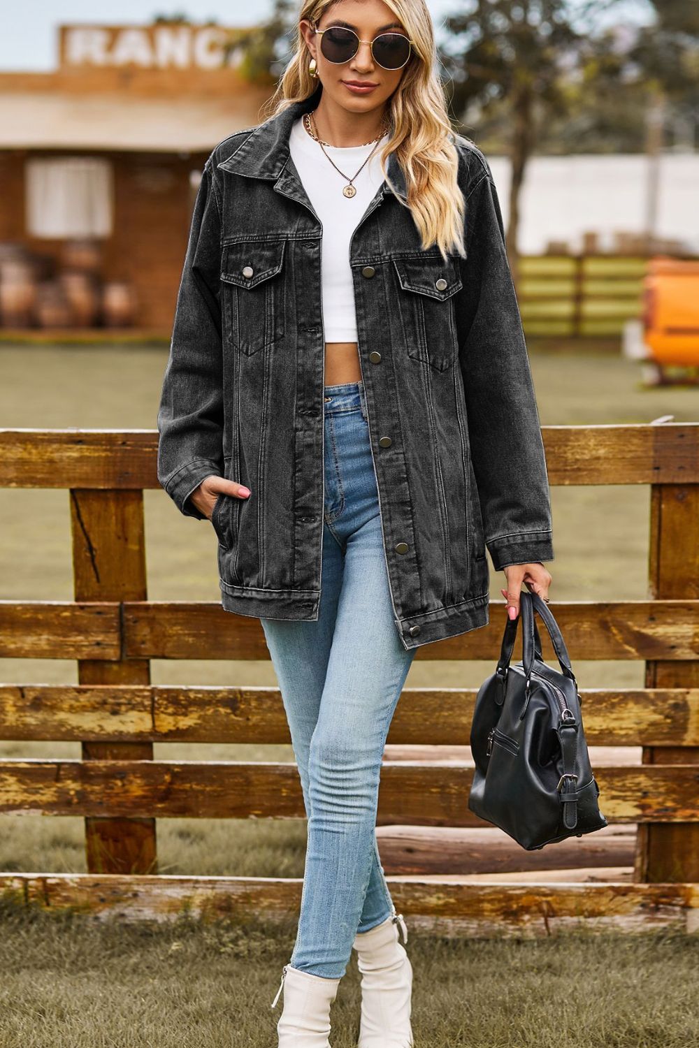 Black oversized denim trucker jacket with classic buttoned front and chest pockets.