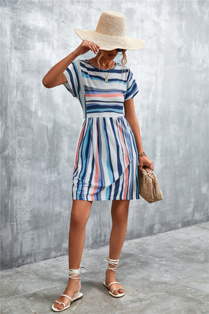 Striped yoke-seam trapeze dress with short sleeves and a round neckline in multi-color stripes.