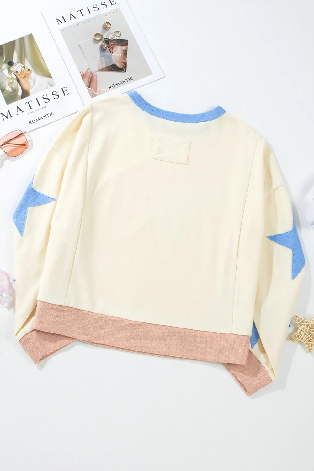 Ivory cotton sweatshirt with blue star sleeves and a contrast hem.