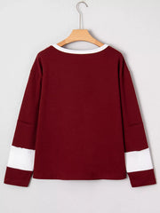 Burgundy long sleeve top with white trim and sleeve details