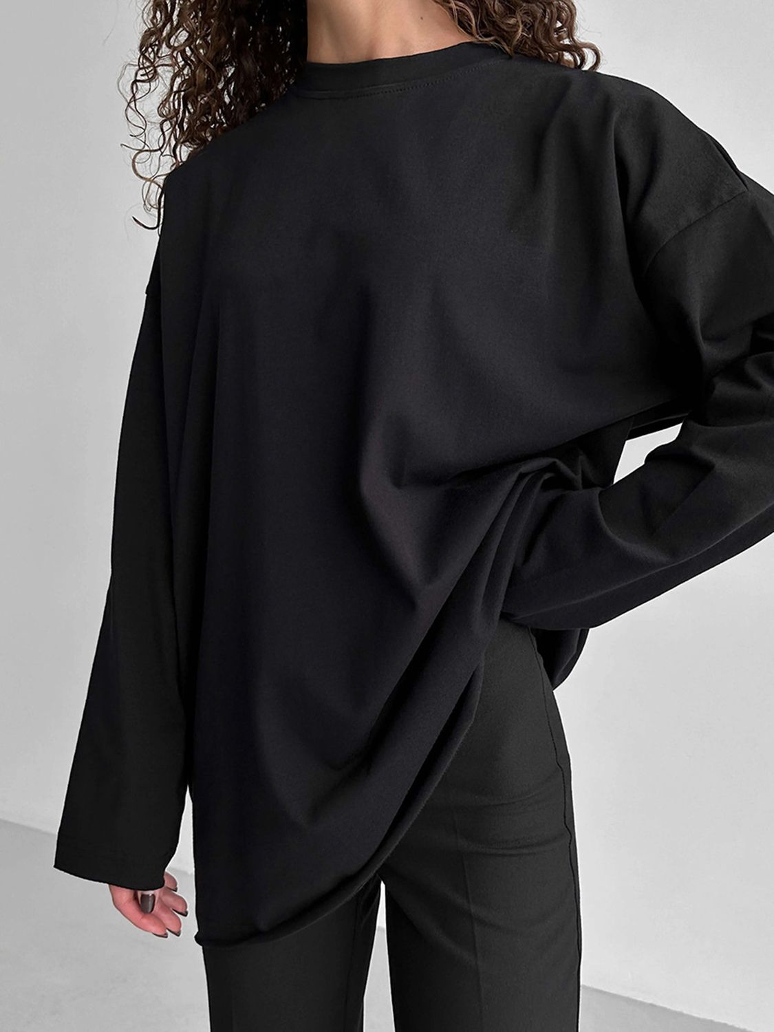 Black oversized cotton jersey top with long sleeves and a relaxed fit.