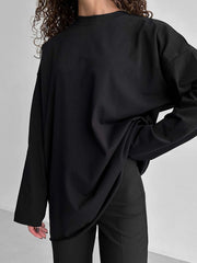 Black oversized cotton jersey top with long sleeves and a relaxed fit.