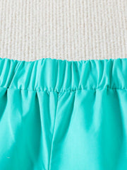 Sky blue toddler shorts with elastic waistband and gathered detail.
