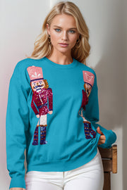 Cerulean crewneck sweater with sequin nutcracker embellishments on front.