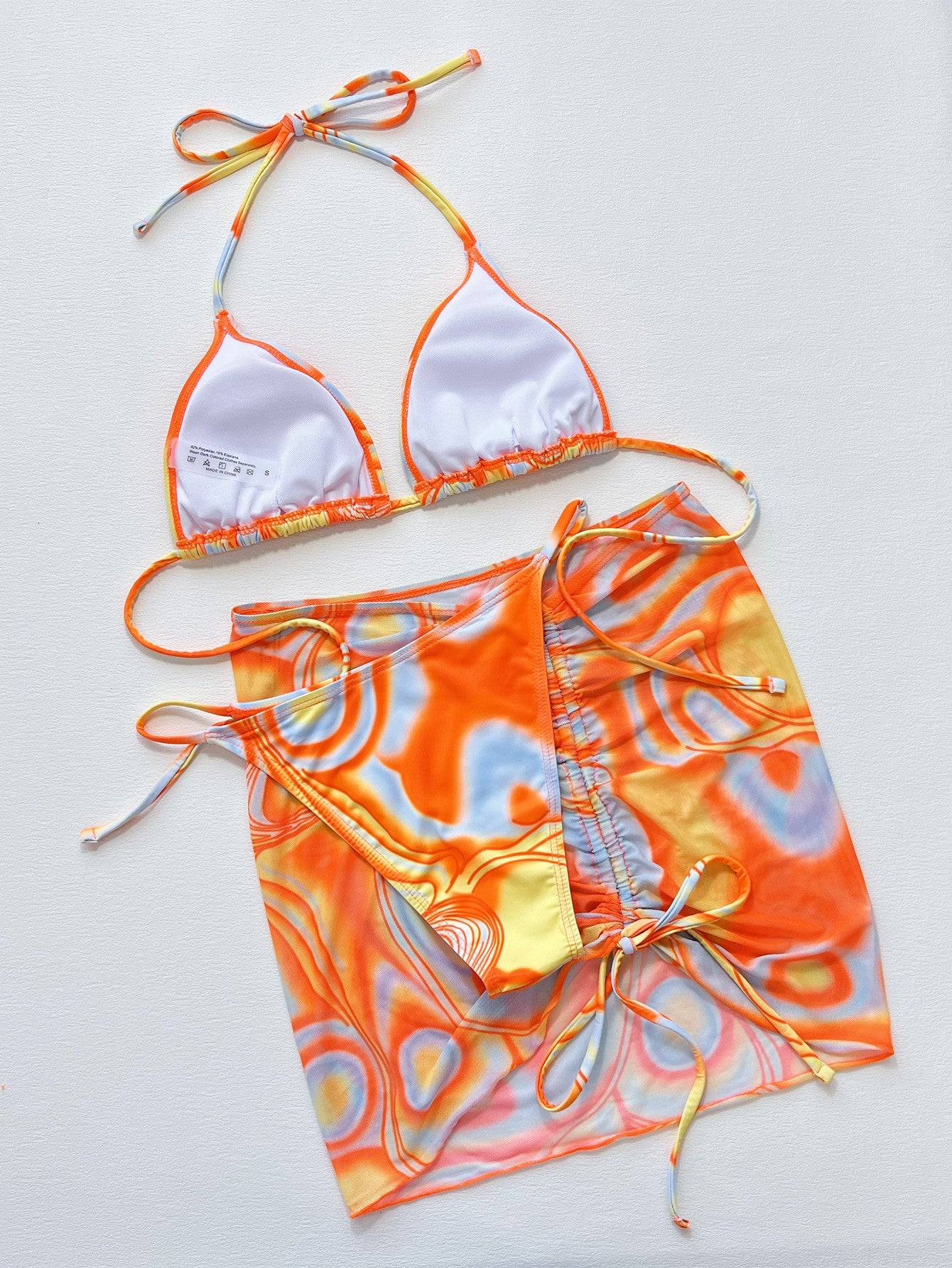 Multicolor swirl print string bikini set with a matching wrap skirt.