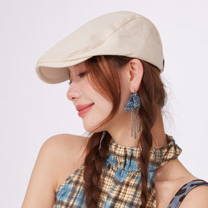 Premium cotton newsboy cap in white, styled with a plaid top.