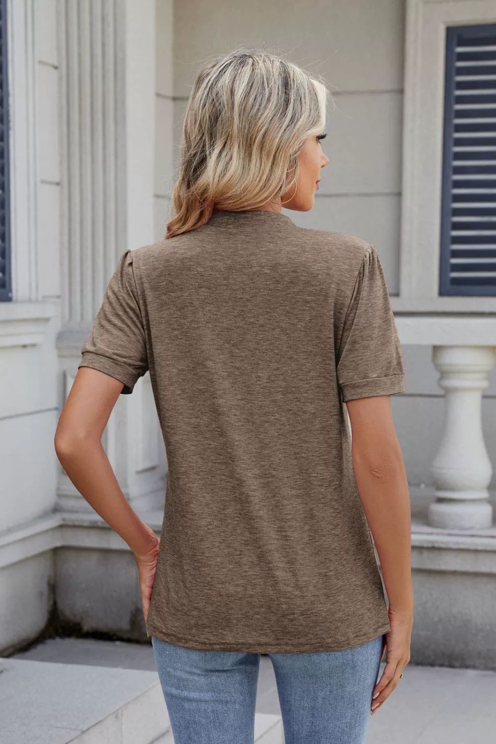 Khaki t-shirt with pleated yoke and short sleeves, shown from the back.
