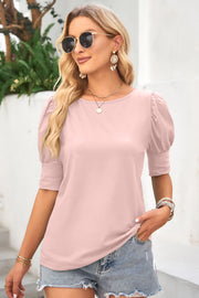 Blush pink crew neck top with short puffed sleeves and cuff detail.