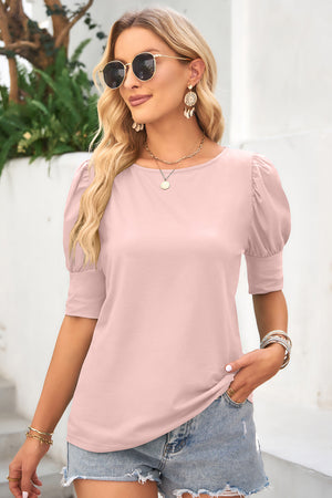 Blush pink crew neck top with short puffed sleeves and cuff detail.