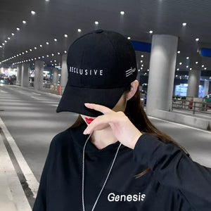 Black cotton baseball cap with white RECLUSIVE embroidery and side detail.