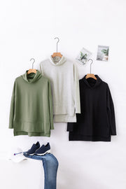 Army green, light gray, and black tunics with cowl necklines and side slits.